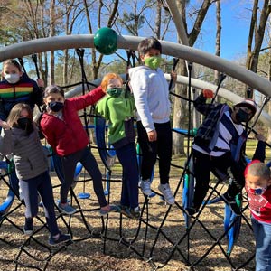 Photo of children playing on the jungle gym