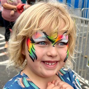 Photo of a happy little girl with her face painted