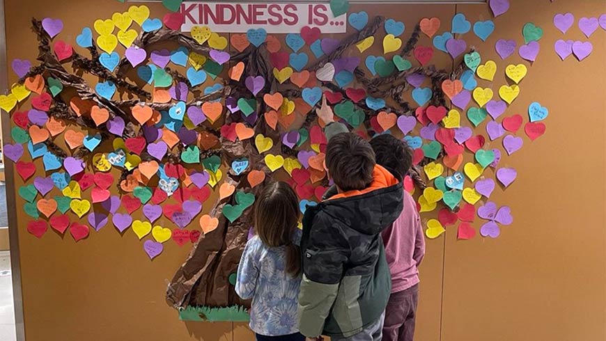 Photo Of Children Looking At A Kindness Is Wall Display At Parkwood Elementary